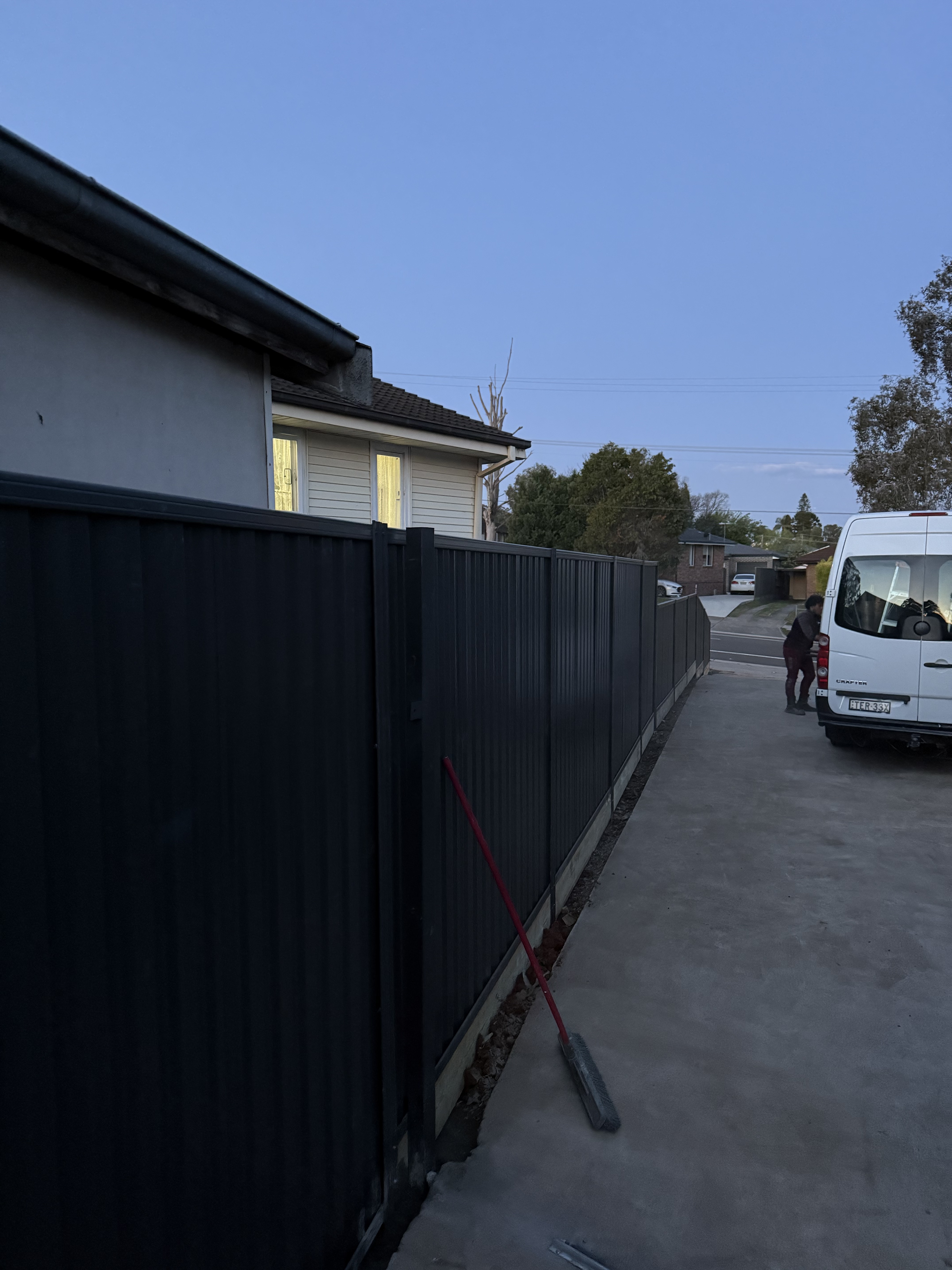 Colorbond boundary fence installed along residential driveway