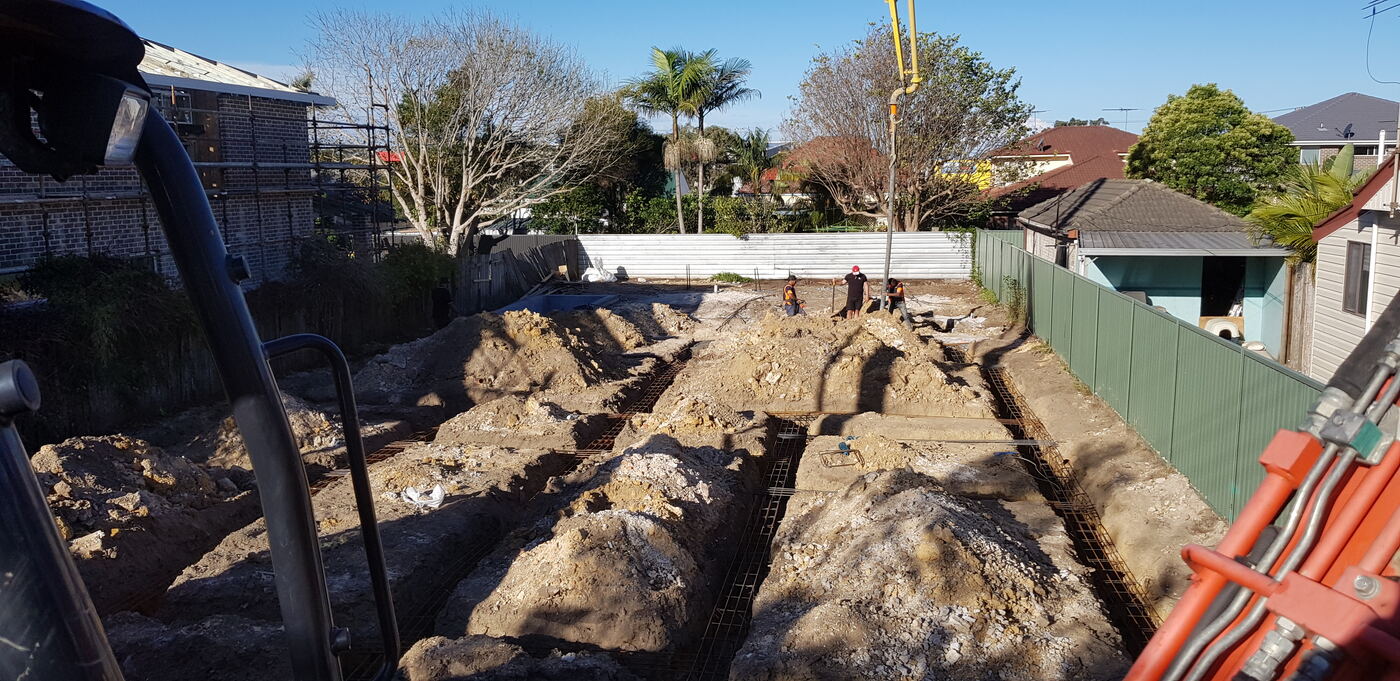 Footing trenches excavated with reinforcement ready for pour