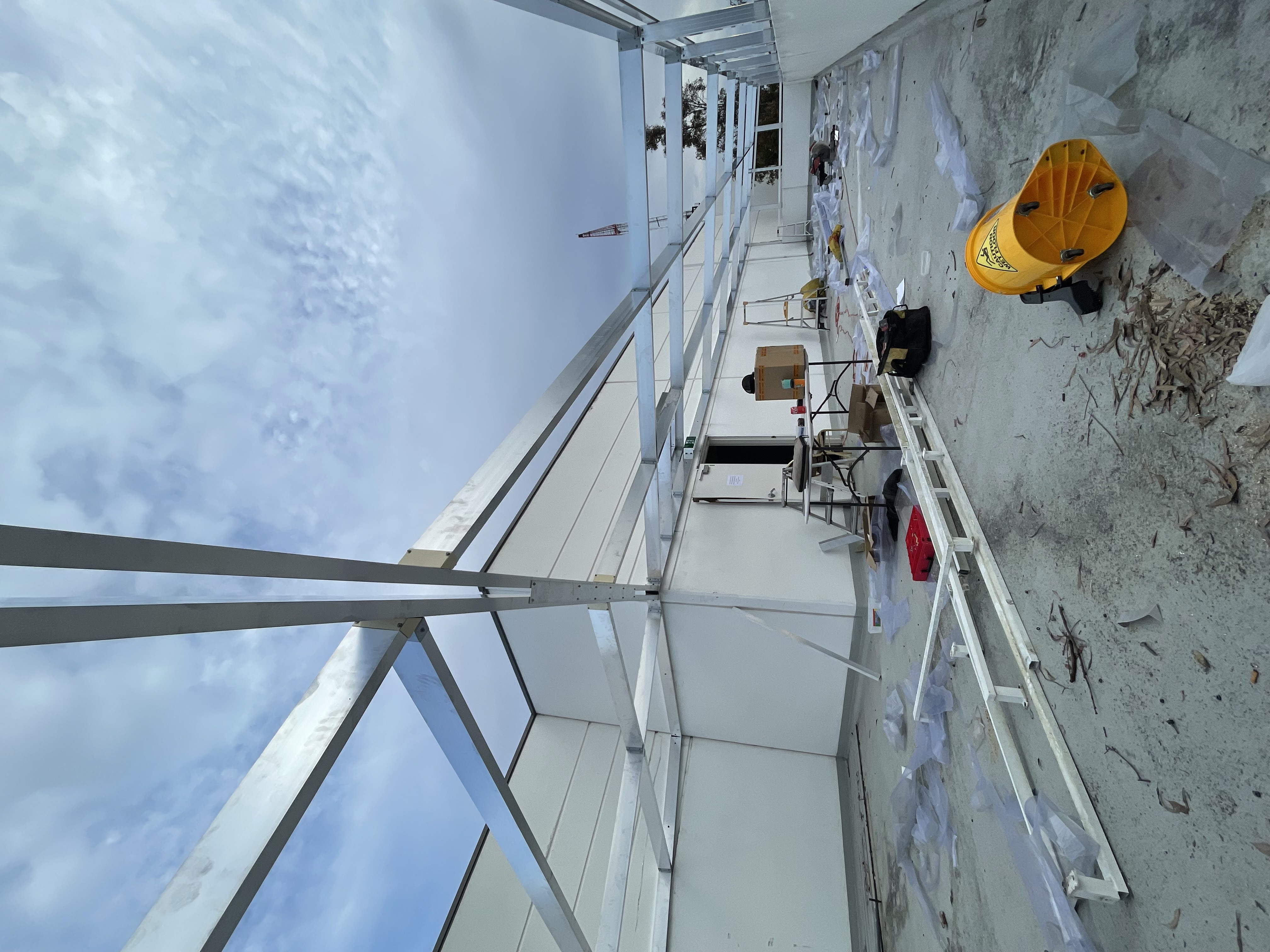 Steel roof framing under construction on commercial building rooftop